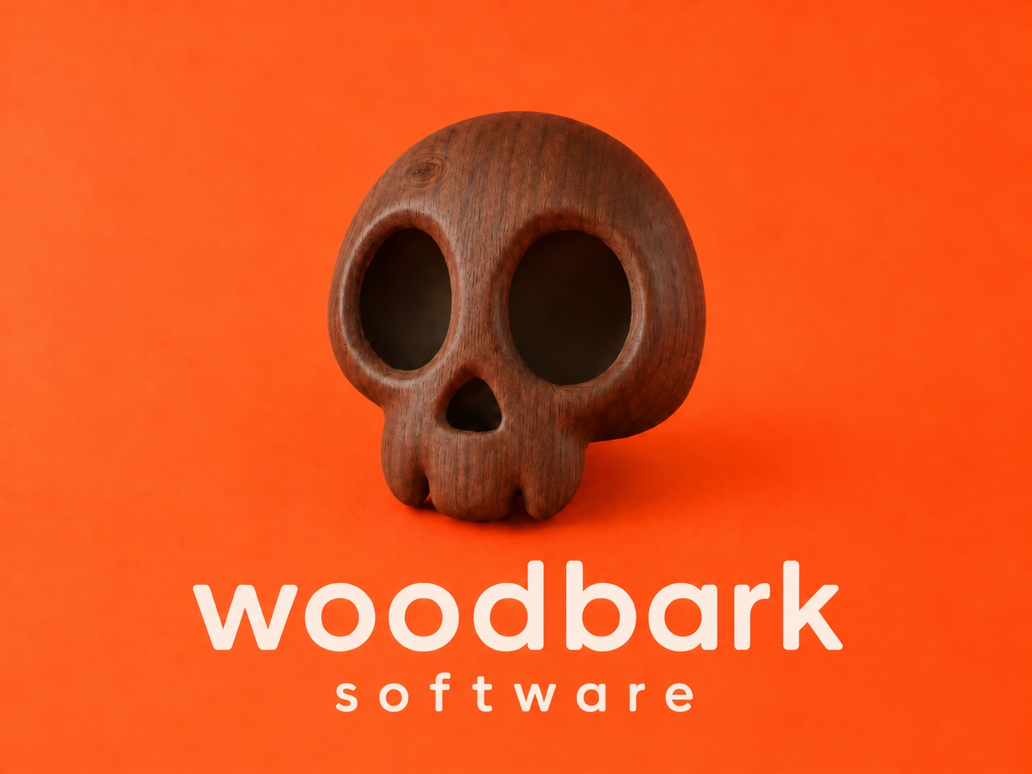 A carved wooden skull against an orange background